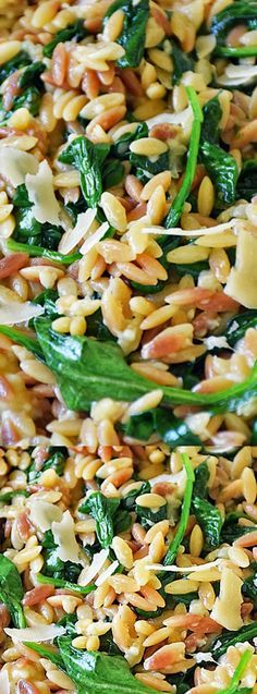 a bowl filled with rice and spinach on top of a table