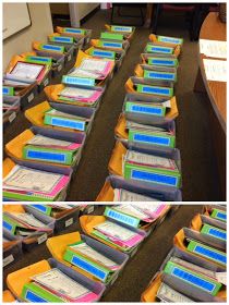 several stacks of folders sitting on top of each other in front of a desk