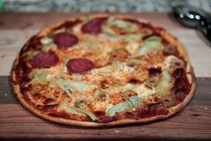 a pizza sitting on top of a wooden cutting board