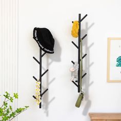 there are two coat racks with hats on them