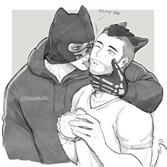 a man in a batman mask hugging another man