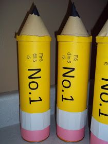 three yellow and pink pencils sitting next to each other on top of a counter