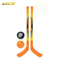 two orange hockey sticks and an orange ball