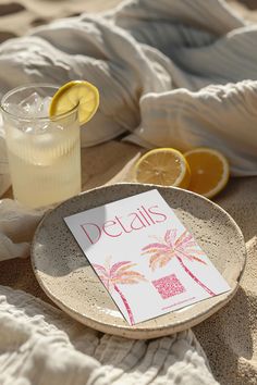 a plate with a note that says details on it next to some lemons and a drink