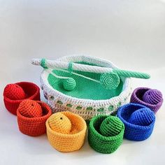 several crocheted bowls and cups sitting next to each other