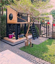 a small house made out of wood and metal with stairs leading up to the roof