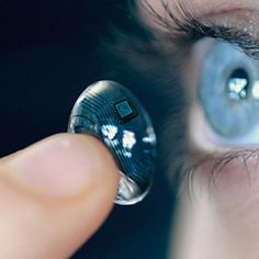 an eye looking through a magnifying glass with the reflection of a computer chip in it