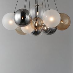 a modern chandelier with five globes hanging from it's center point