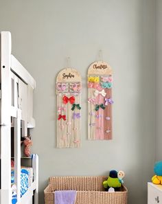 a baby's room with two cribs hanging on the wall