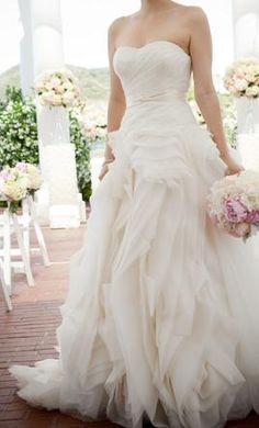 a woman in a wedding dress holding a bouquet