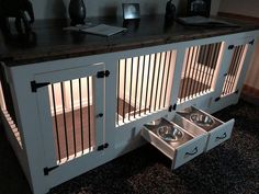 a dog kennel with two bowls in it