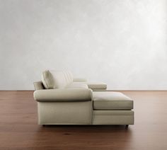 a white couch sitting on top of a wooden floor