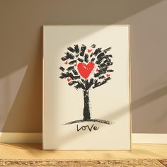 a heart - shaped tree with the word love written on it in black and red ink