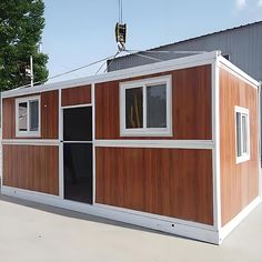 a small house made out of wood and metal