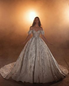 a woman in a wedding dress posing for the camera