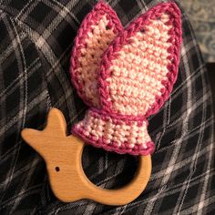 a crocheted toy with a wooden teethpick attached to it's ear