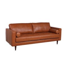 a brown leather couch sitting on top of a white floor