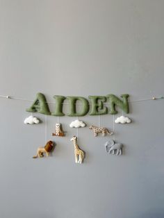 the name alden is made out of clay with animals hanging from it's sides