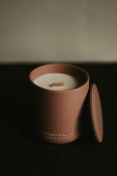 a pink cup sitting on top of a table