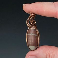 Shiva Lingam stone wire wrapped pendant with oxidized patina copper wire. Please note that this wire may tarnish and will need cleaning from time to time. Polish as needed with included polishing cloth.All pendants come in a jewelry gift box with a black waxed cord and small polishing cloth.Size: 43 x 13 x 12 mm. 10 grams. this stone is from India Lingam Shiva, Patina Copper, Shiva Lingam, Copper Patina