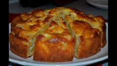 a cake on a white plate with slices cut out