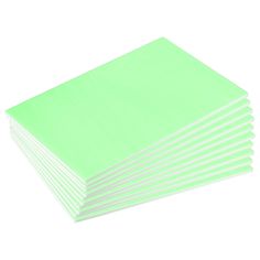 a stack of light green napkins on a white background