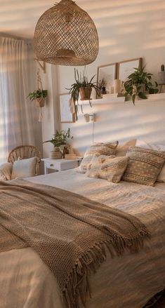 a bed sitting in a bedroom next to a window filled with potted greenery