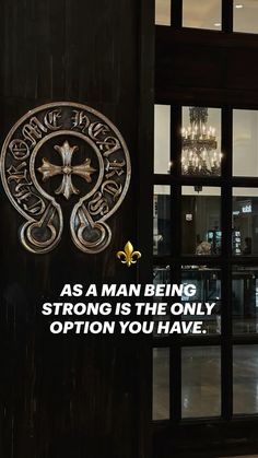 a door with the words as man being strong, strong is the only option you have