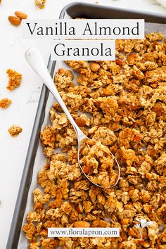 A silver serving spoon on a dark pan covered in vanilla almond granola. Vanilla Granola Recipe, Granola Balls, Honey Almond Granola, Vanilla Granola, Homemade Cereal