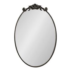 a round mirror with an ornate design on it