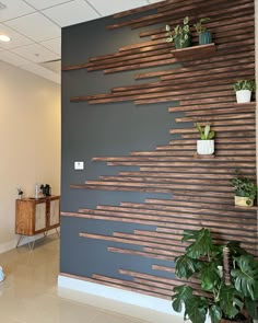 the wall is made out of wood strips and has potted plants on each side