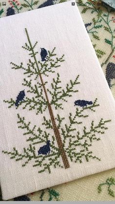 a cross stitch pattern with blue birds on it