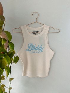 Feel all the TTPD western vibes in our But Daddy, I Love Him micro-ribbed tank!- Features the phrase "But Daddy, I Love Him " across the middle of the tank in a blue ink- Screen print transfer that is heat pressed onto each tshirt- Tshirt is a super soft, 90s style micro ribbed tank- Regular Baby Tee Fit - Cotton / Poly Blend * due to screens and filters colors may vary slightly to photos * Modesty Journey, But Daddy I Love Him, Daddy I Love Him, 90s Sports, Western Vibes, Nashville Trip, Screen Print Transfer, Print Transfer, Western Chic