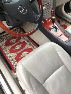 the interior of a car with a steering wheel and dashboard