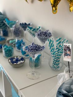 blue and white striped paper straws in vases on a table with other decorations