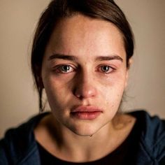 a woman with tears on her face looking at the camera