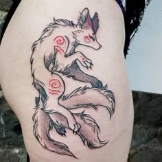 a woman's thigh with a tattoo of a fox sitting on top of it