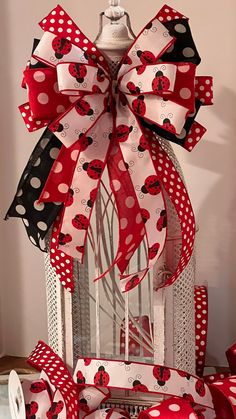 a red and white bow with ladybugs on it sitting on top of a table