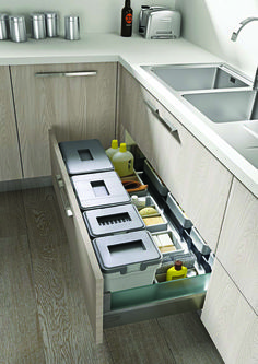 an open drawer in the middle of a kitchen