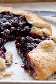 a blueberry pie is cut into pieces and ready to be eaten