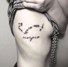 a woman's stomach with the word scorpion written in cursive writing on it