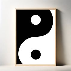 a black and white poster with a yin symbol on the wall next to a shelf