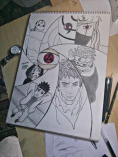 a drawing of some characters on a table next to pens and paper with pencils