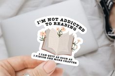 someone is holding up a sticker that says i'm not adopted to reading