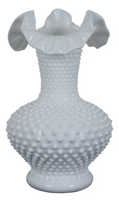 a large white vase with an unusual design on the top and bottom, sitting in front of a white background