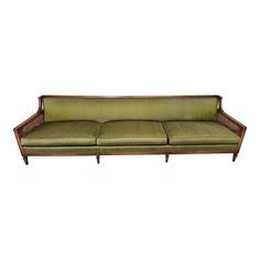 a green couch sitting on top of a wooden frame