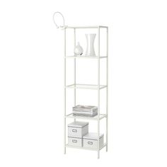 a white shelving unit with three drawers