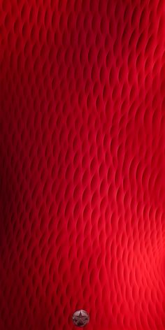 a red wall with circles on it and a lamp in the corner next to it