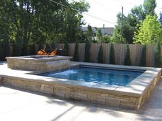 an outdoor hot tub in the middle of a backyard