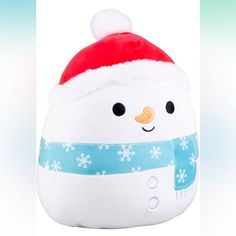 a white snowman with a red hat and blue scarf on it's head